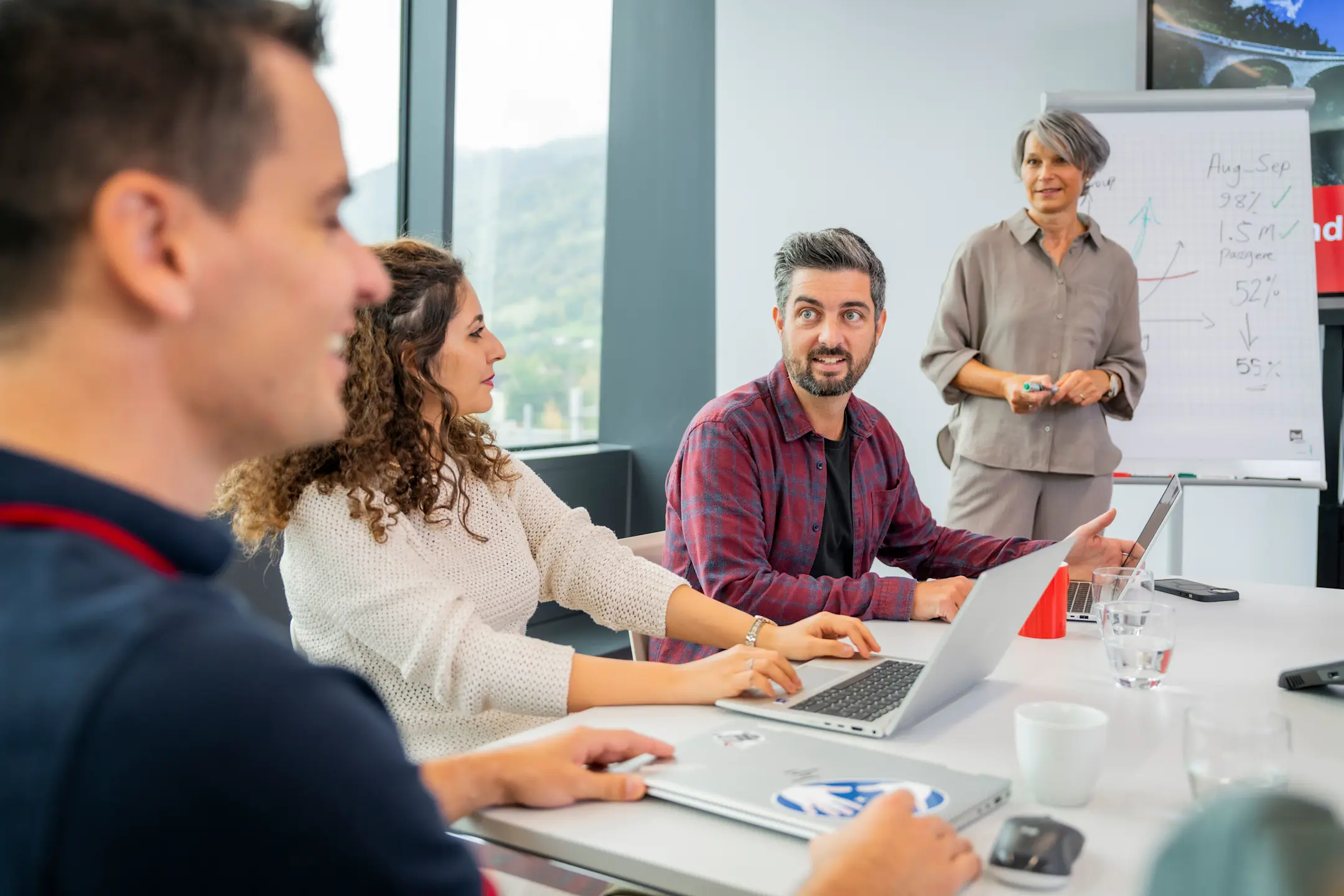 Employees discuss matters at a meeting