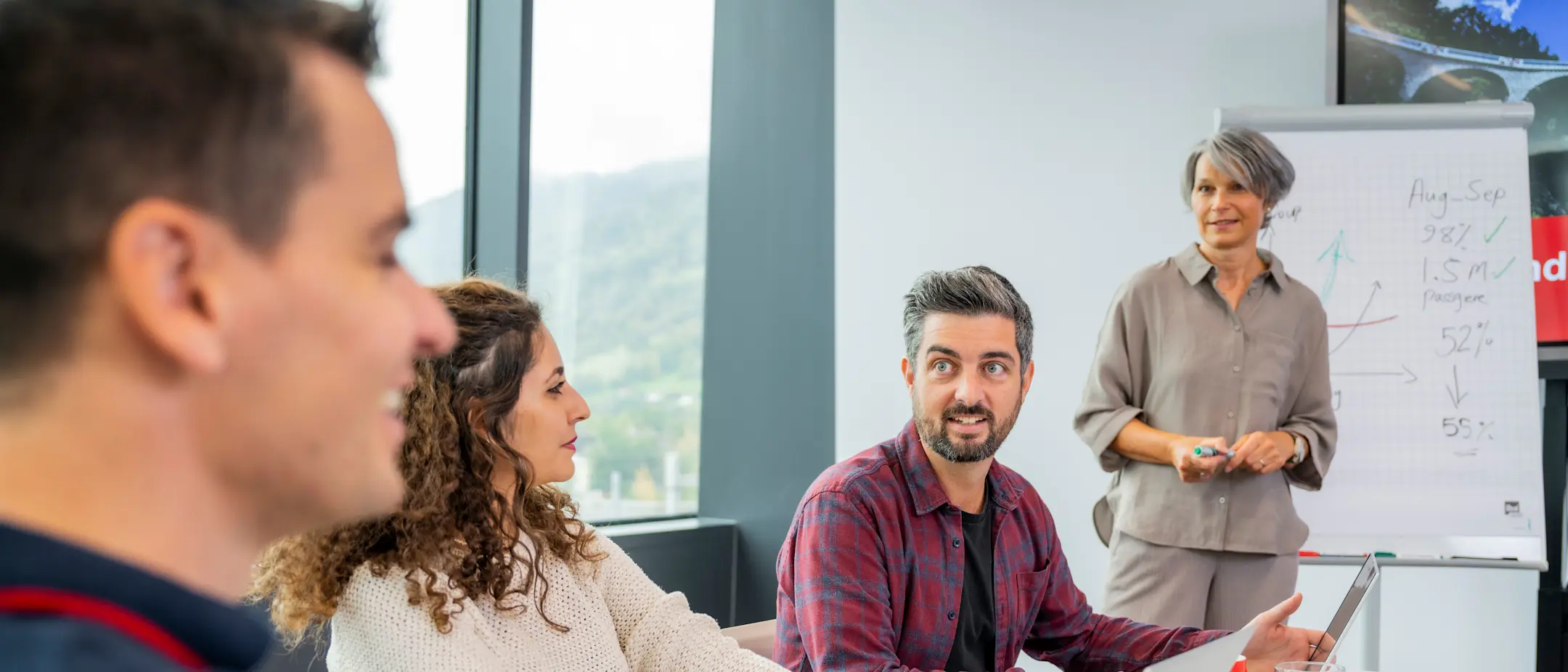 Employees discuss matters at a meeting