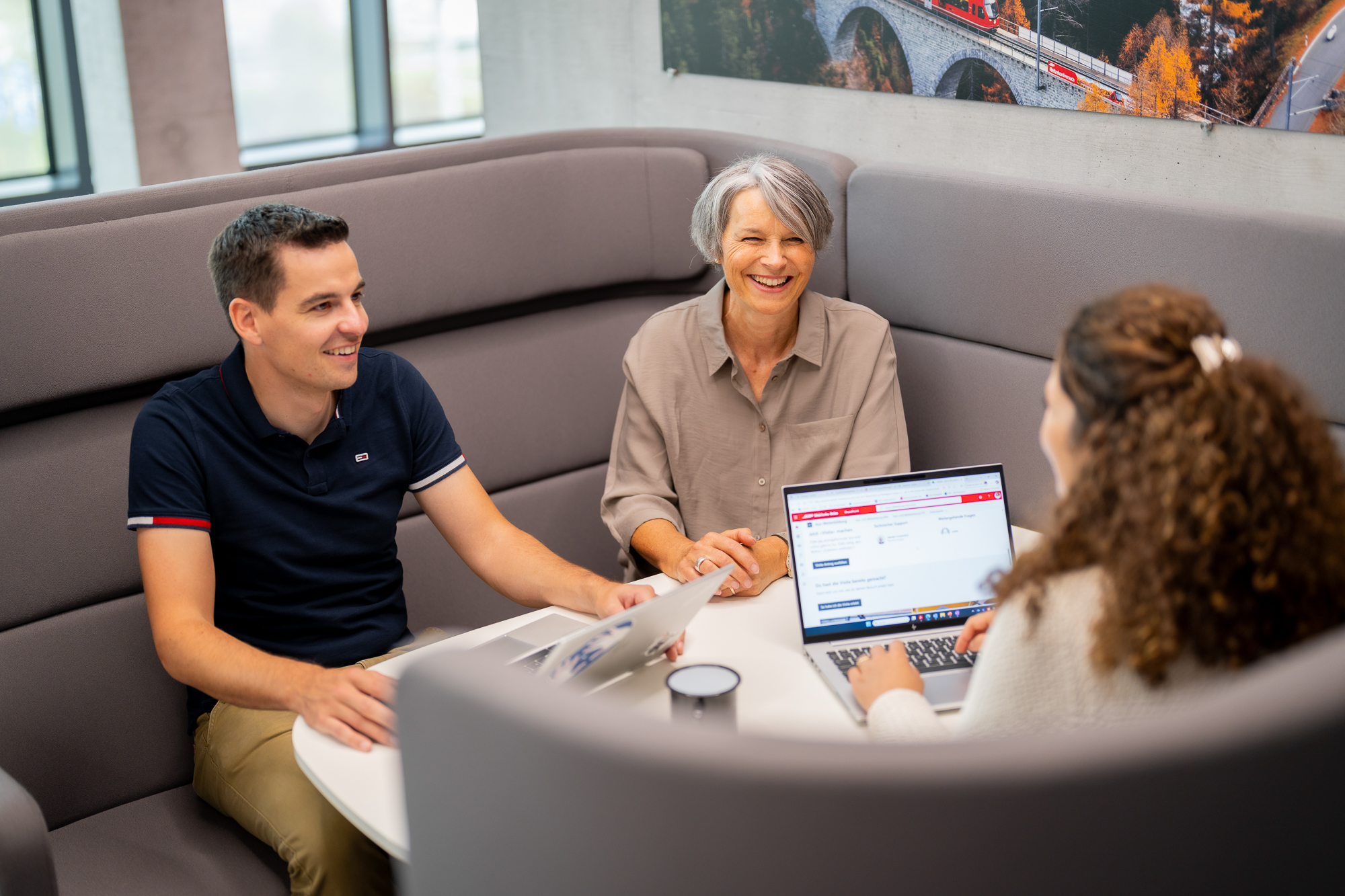 Three RhB employees discuss matters at a meeting.