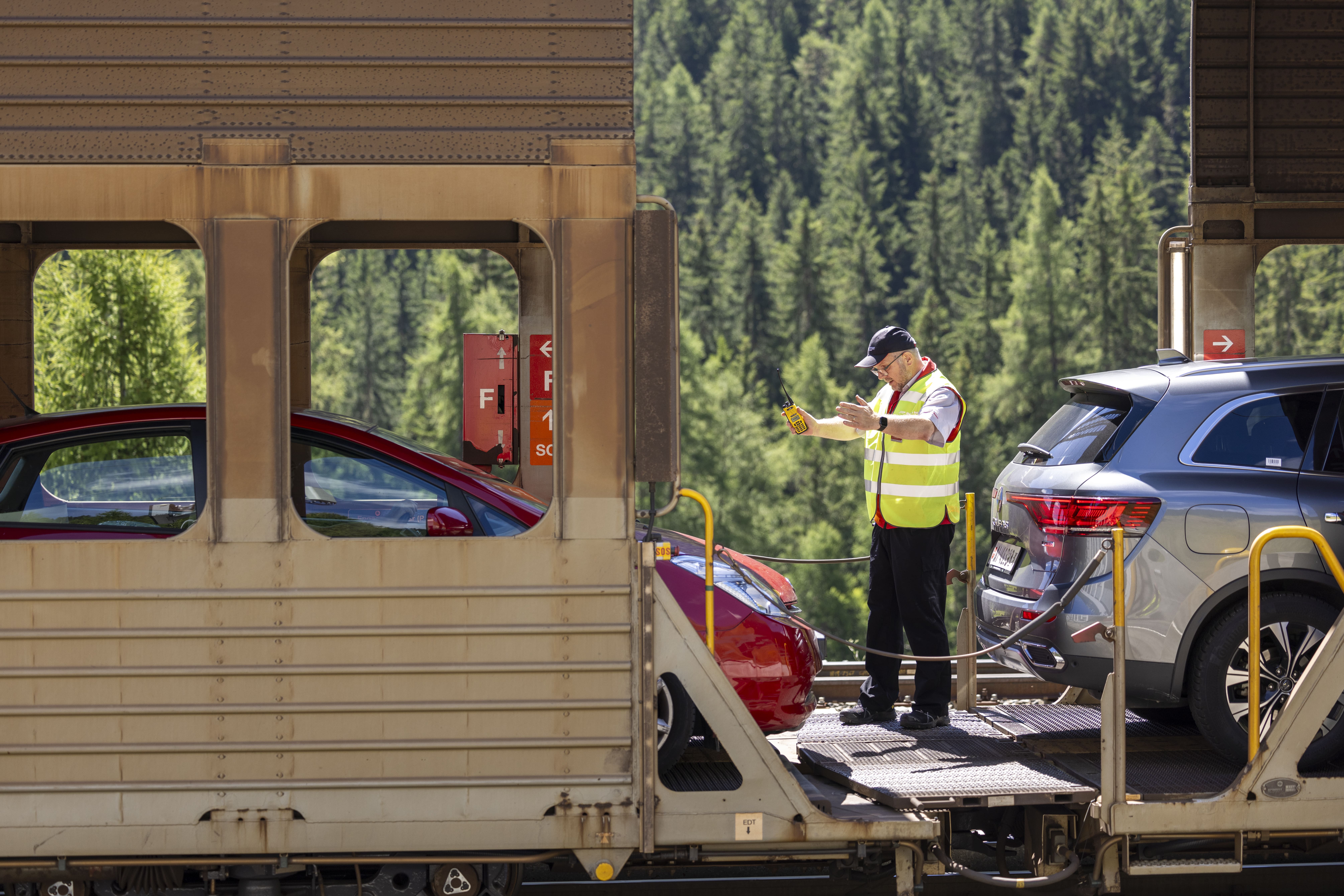 Rhaetian Railway employees checking vehicles on the car transporter train in the Vereina Tunnel.