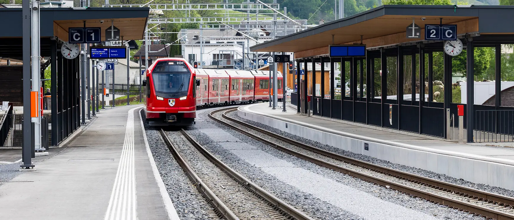 Zwei gekuppelte Capricorn-Triebzüge fahren durch den Bahnhof Trun.