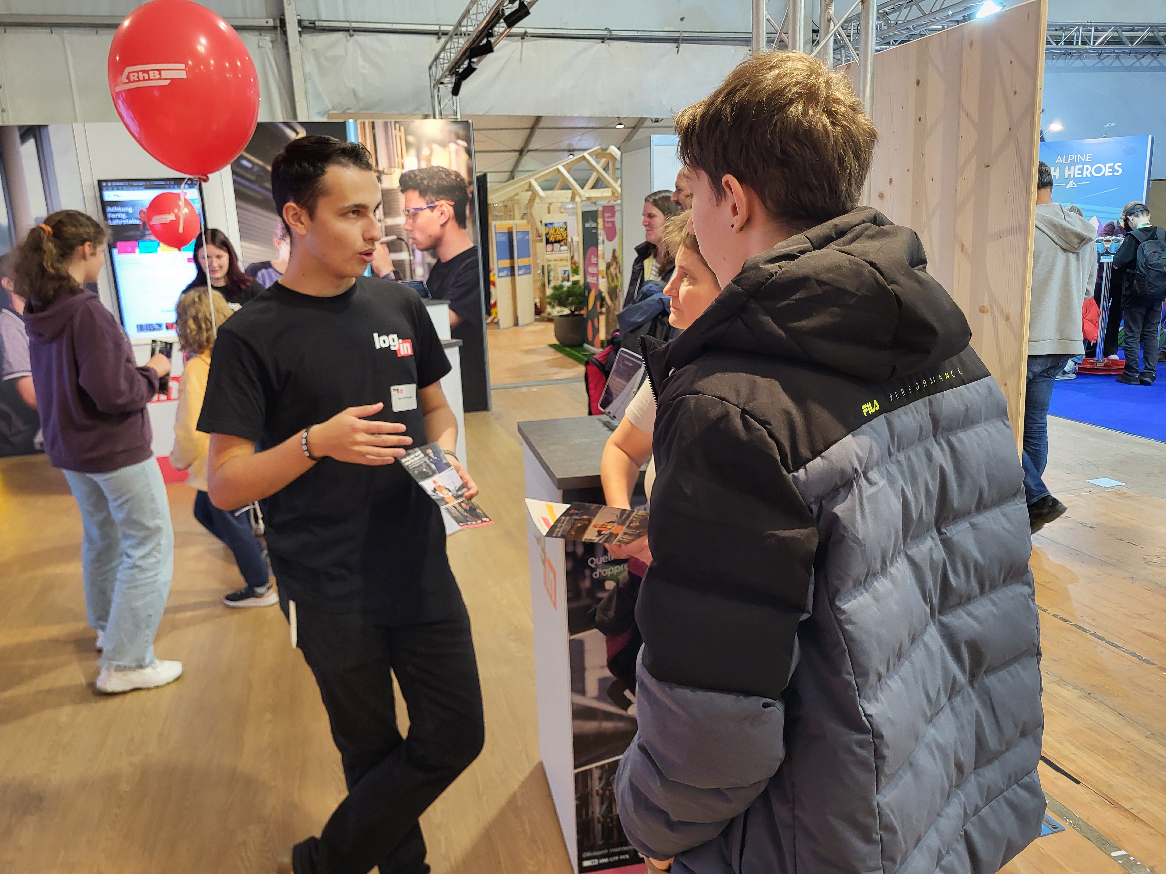 Ein Login Lernender erklärt am RhB Stand den Beruf