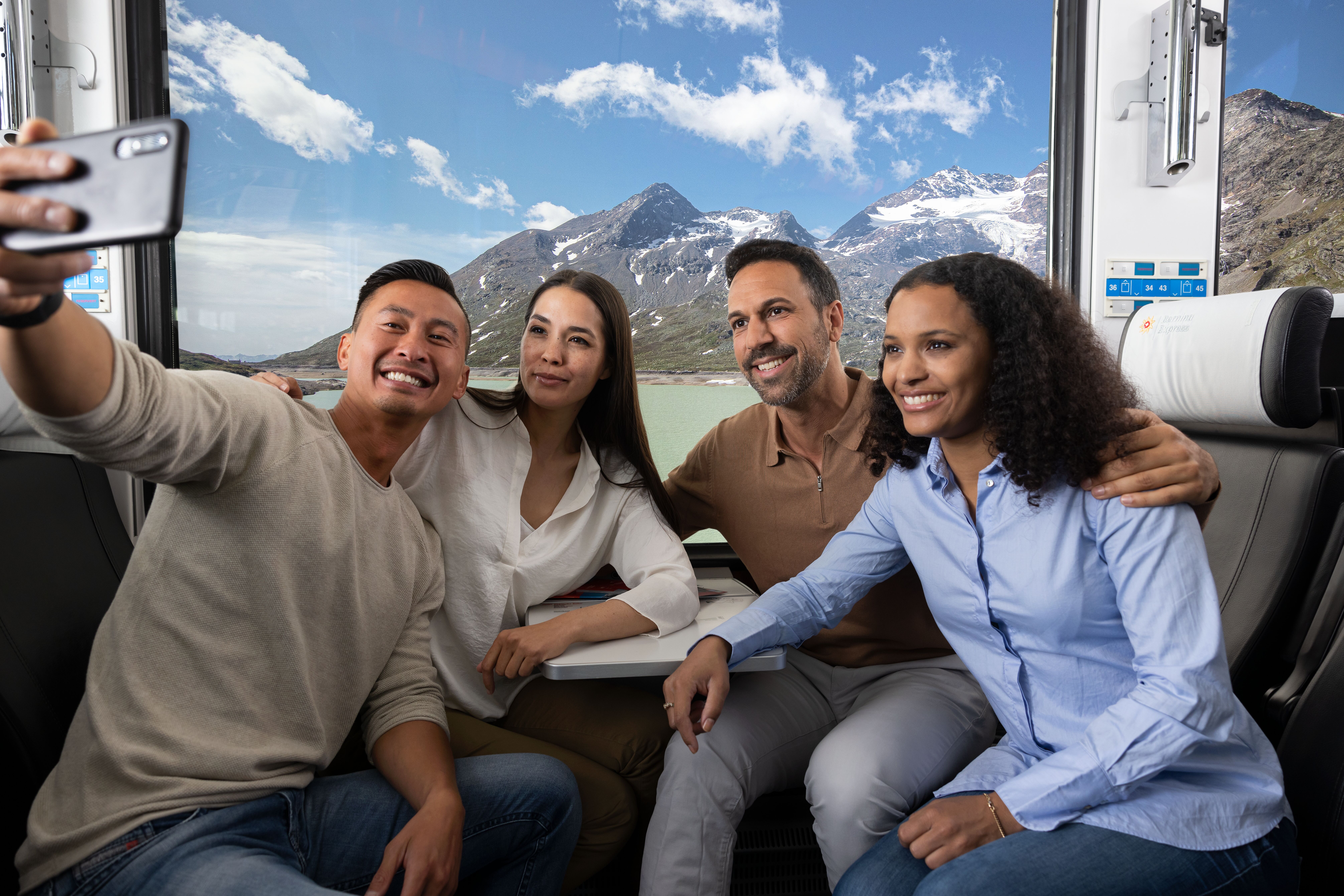 Four passengers take a selfie on the Bernina Express.