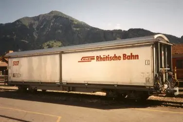 Ein Schiebewandwagen vom Typ Haik mit dem Logo der Rhätischen Bahn