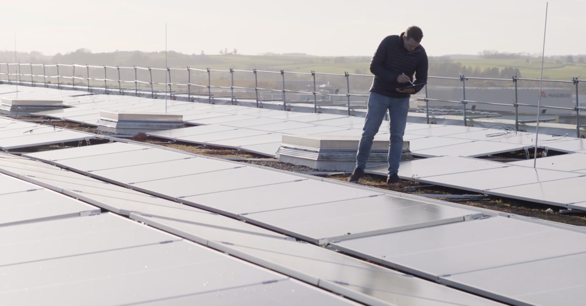 Construction worker from Elektro Scherer checking the installation of a solar system project in the Fieldwire app.