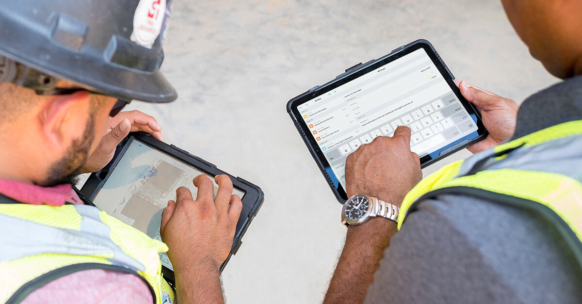 Two crew members using Fieldwire in the field on their tablets