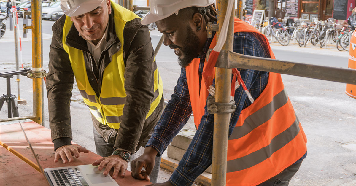 Construction teams use Fieldwire on jobsite using a laptop