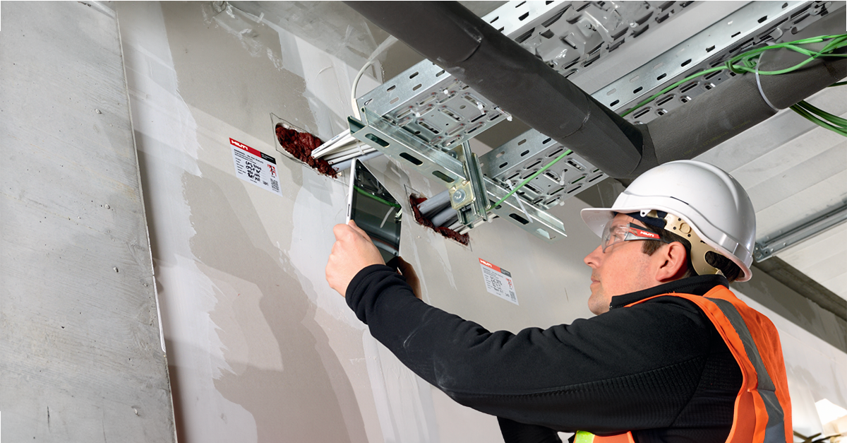 Construction worker using Fieldwire on the jobsite for firestop documentation