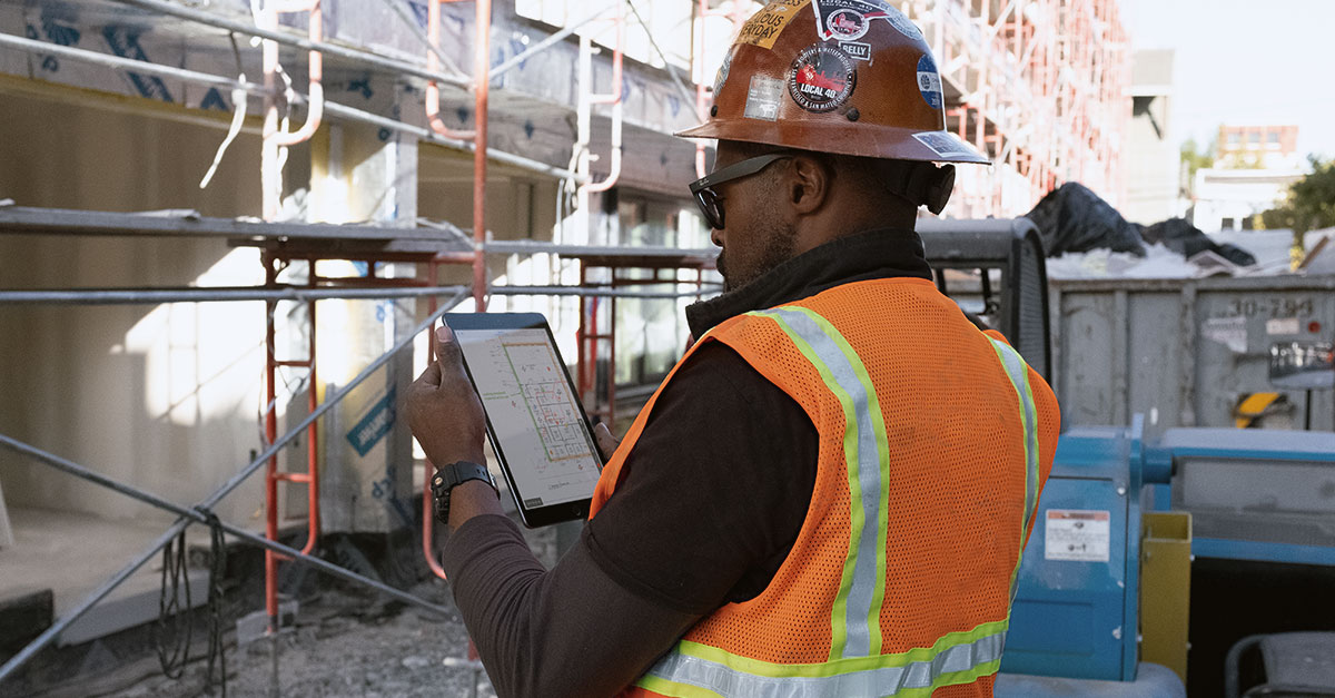 Workers in the field using Fieldwire on a phone and a tablet to communicate and manage workflows.