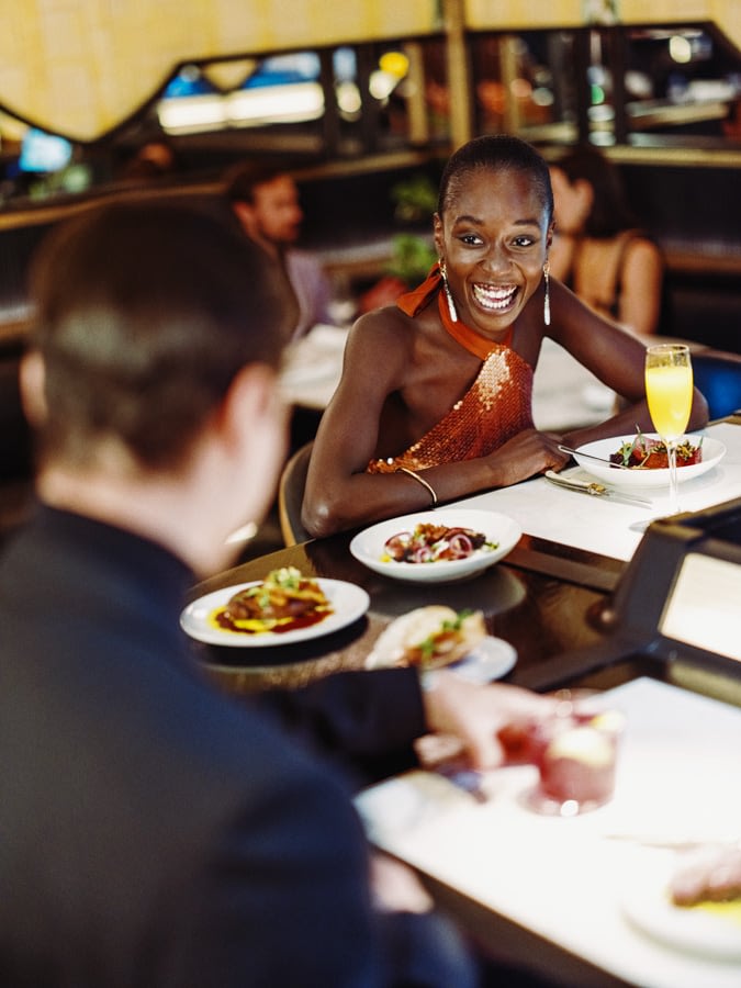 Two people eating dinner and laughing