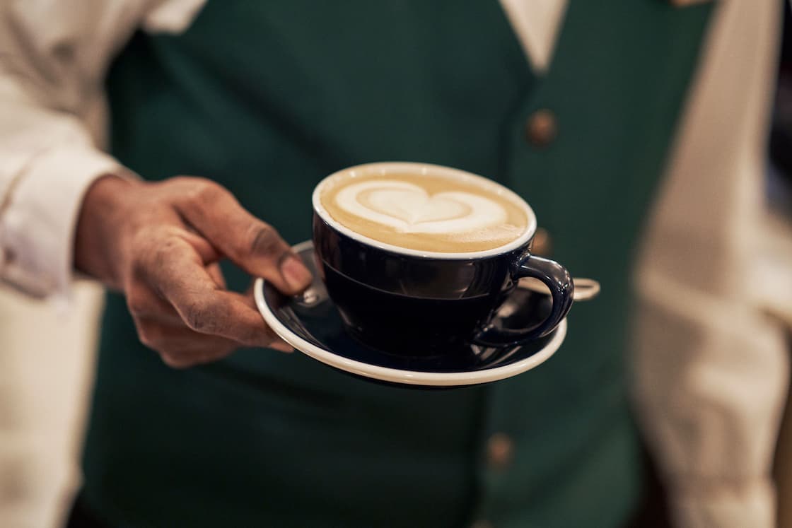 Barista holding coffee