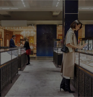 Customers in the Fine Jewellery department looking at jewellery with staff