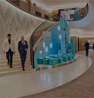 People walking down the stairs in the Fine Watch boutique space
