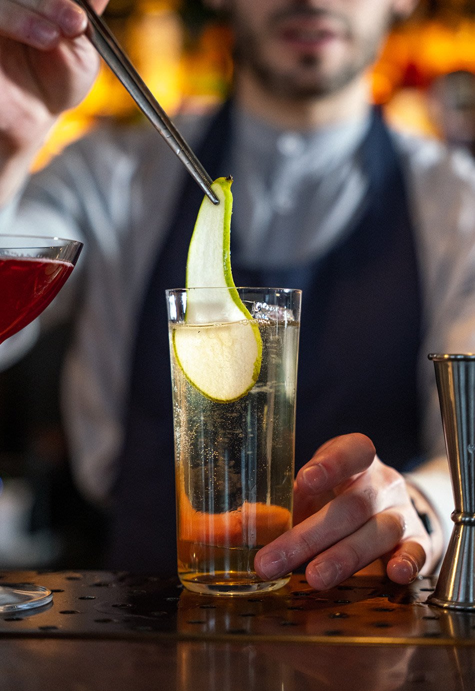 Bartender making a cocktail with cucumber