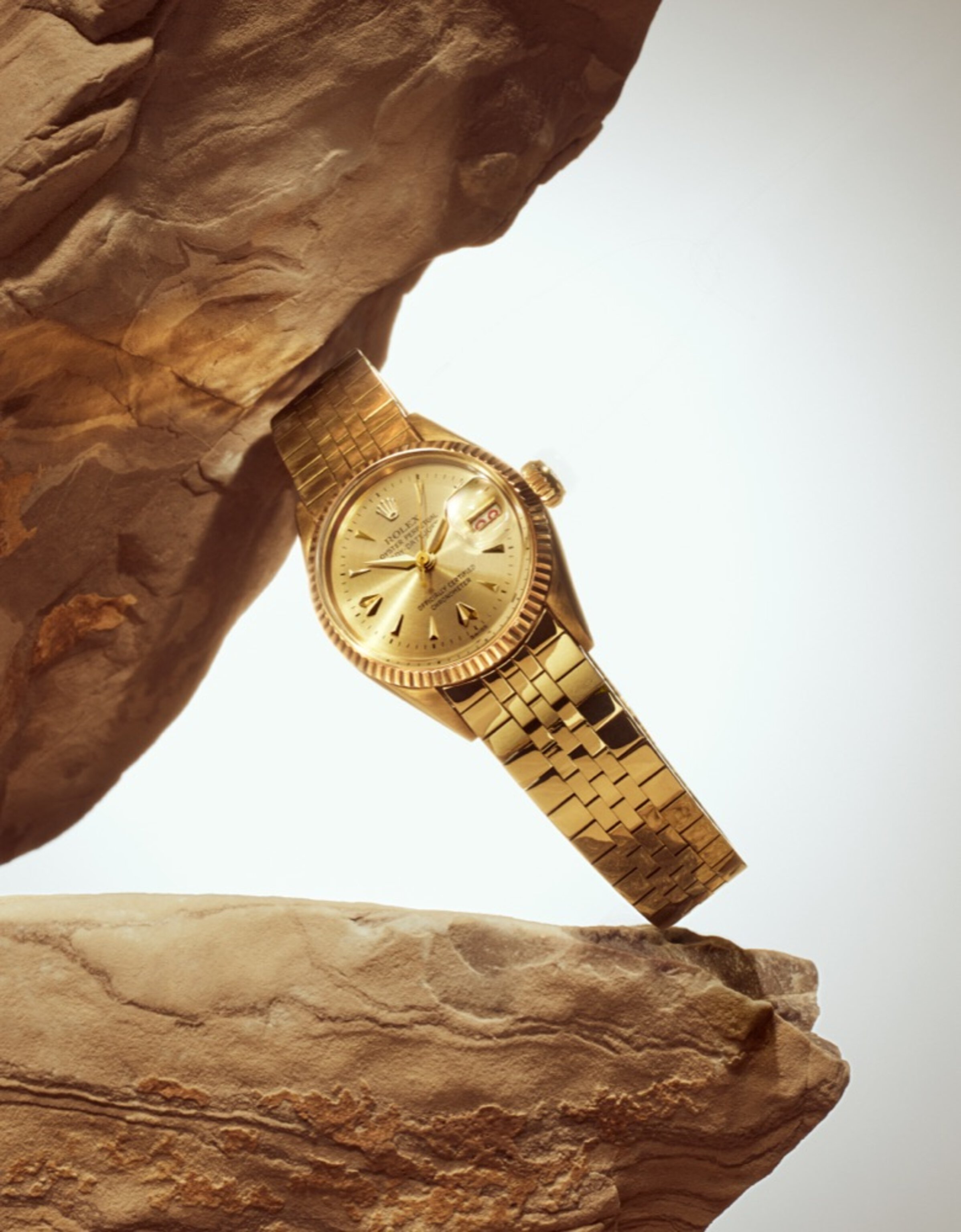 Gold Lady-Datejust watch leaning on rock