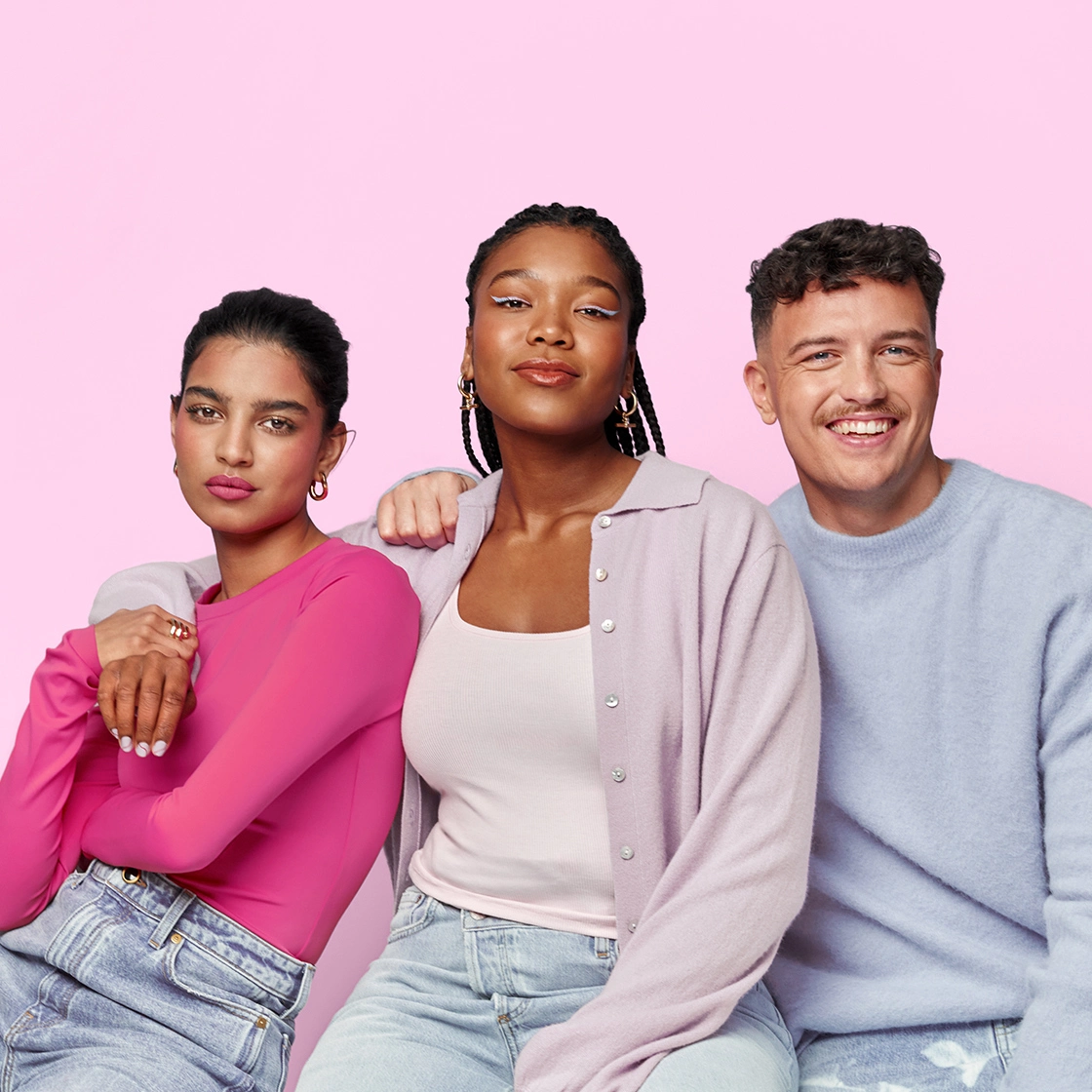 3 friends sat with each other smiling