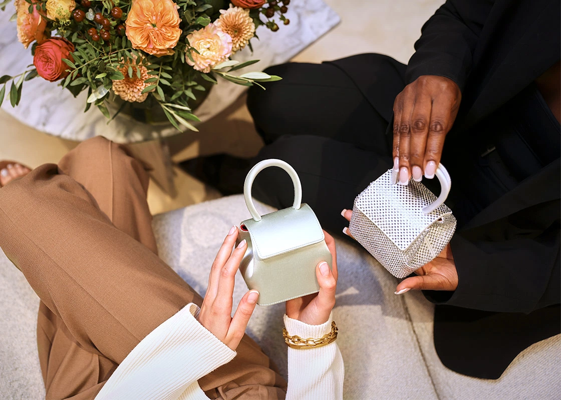 Friends looking at micro handbags