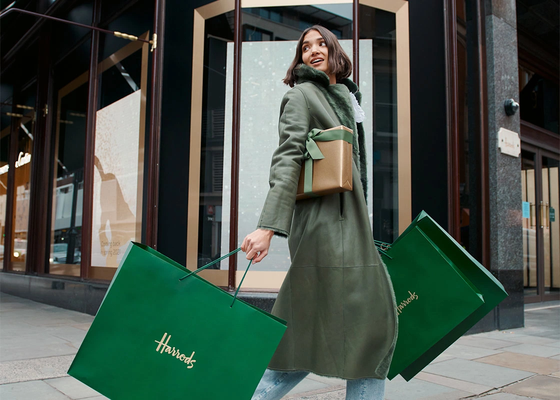 Lady carrying Harrods shopping bags