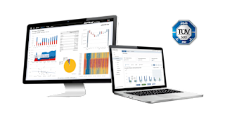 Desktop and laptop screens displaying Janitza energy management software with TÜV SÜD certification logo