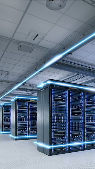 Modern data center with illuminated servers for data storage and processing.