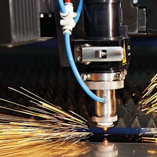 Industrial laser cutting machine with sparks during the cutting process