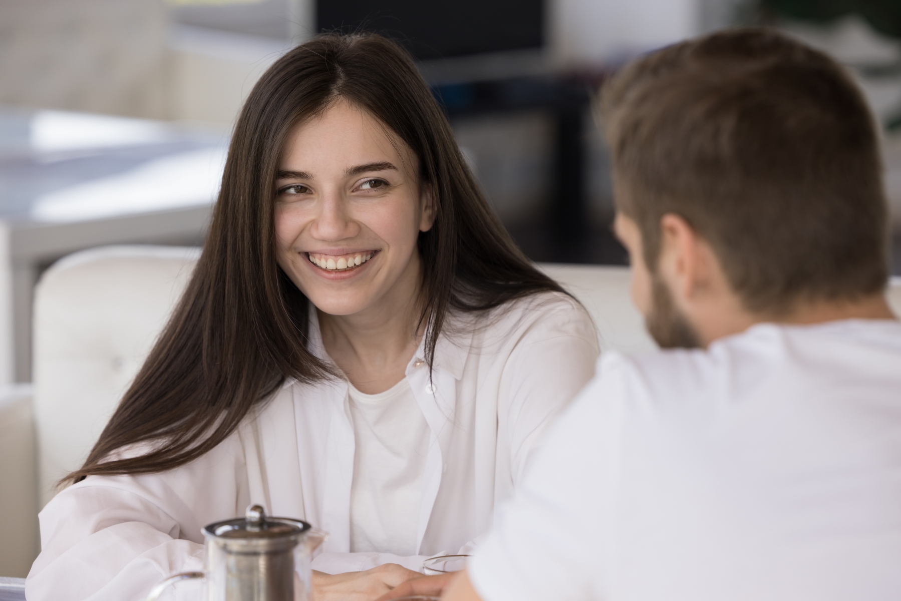 Young woman sitting in a cafe on a date.