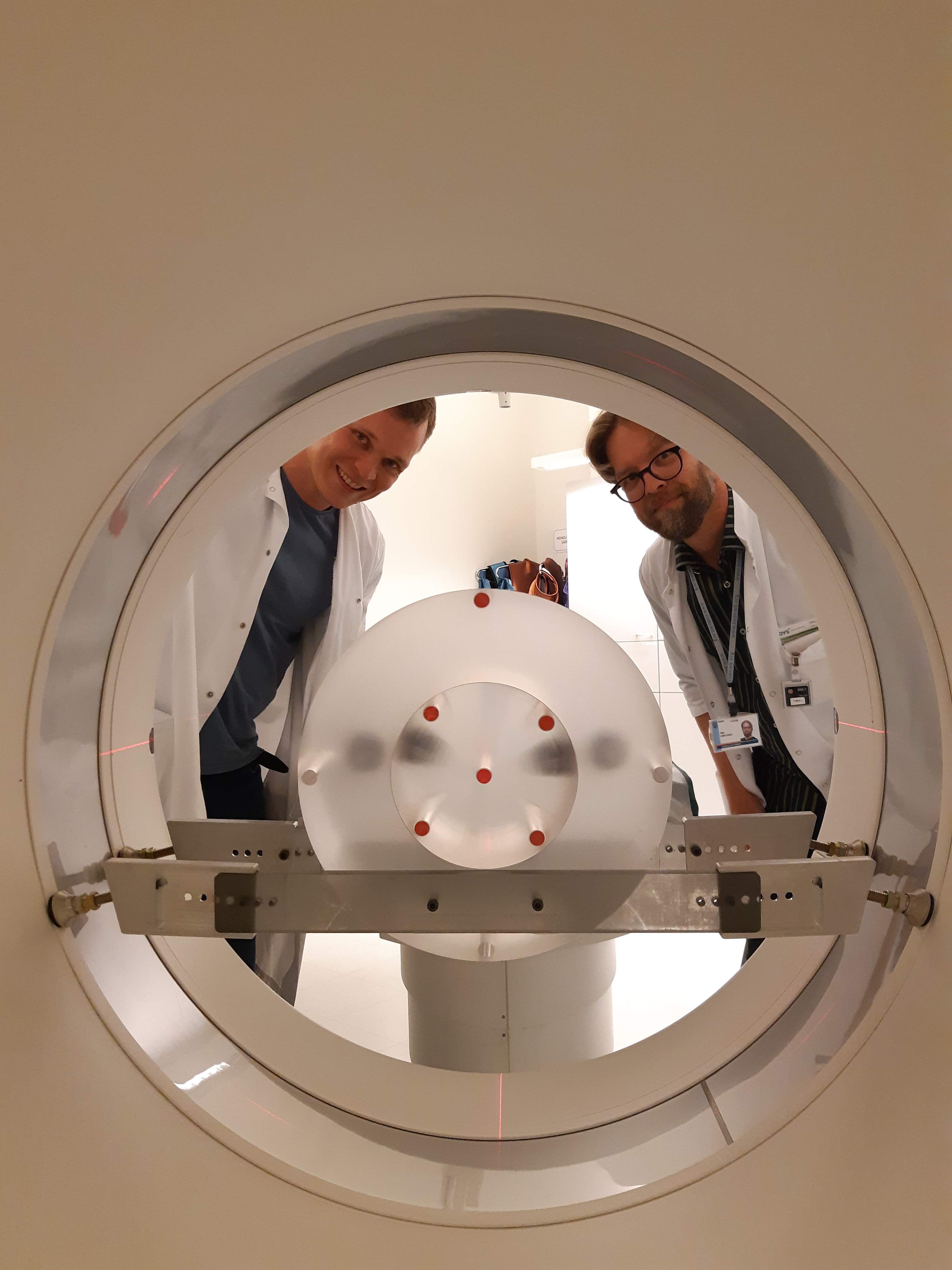 Physicists performing a CT scanner quality assurance test