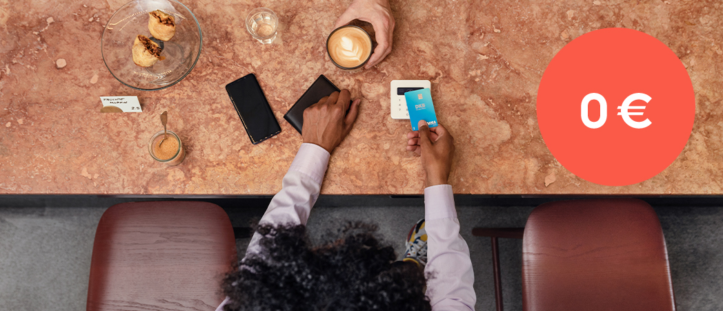 Eine Frau bezahlt ihren Kaffee mit der Visa Debitkarte der DKB