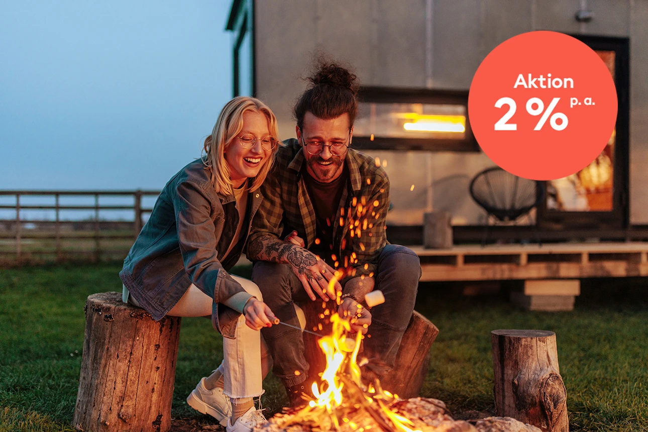 Mann und Frau sitzen am Lagerfeuer