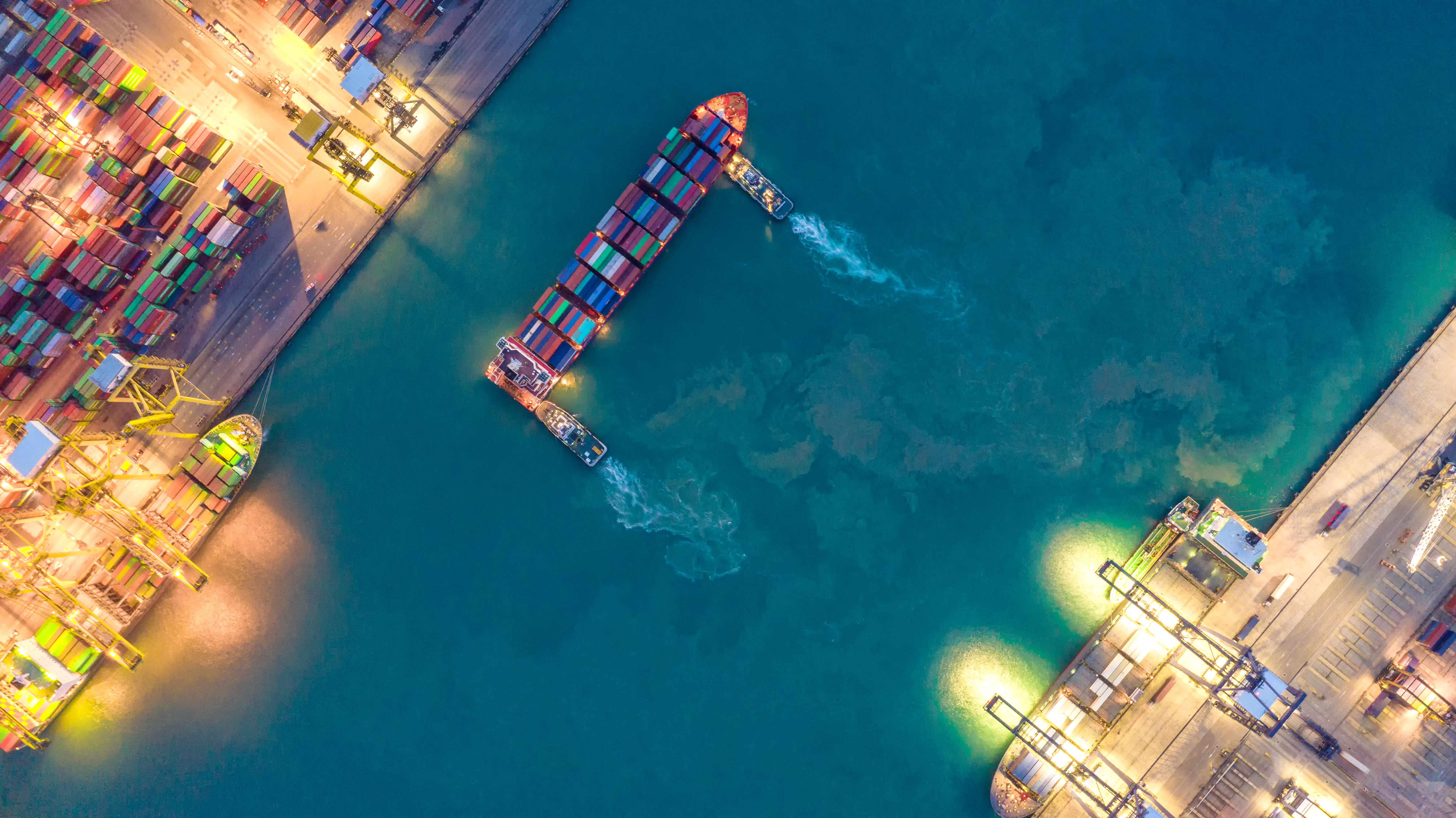 Container ship at harbour seen from above.