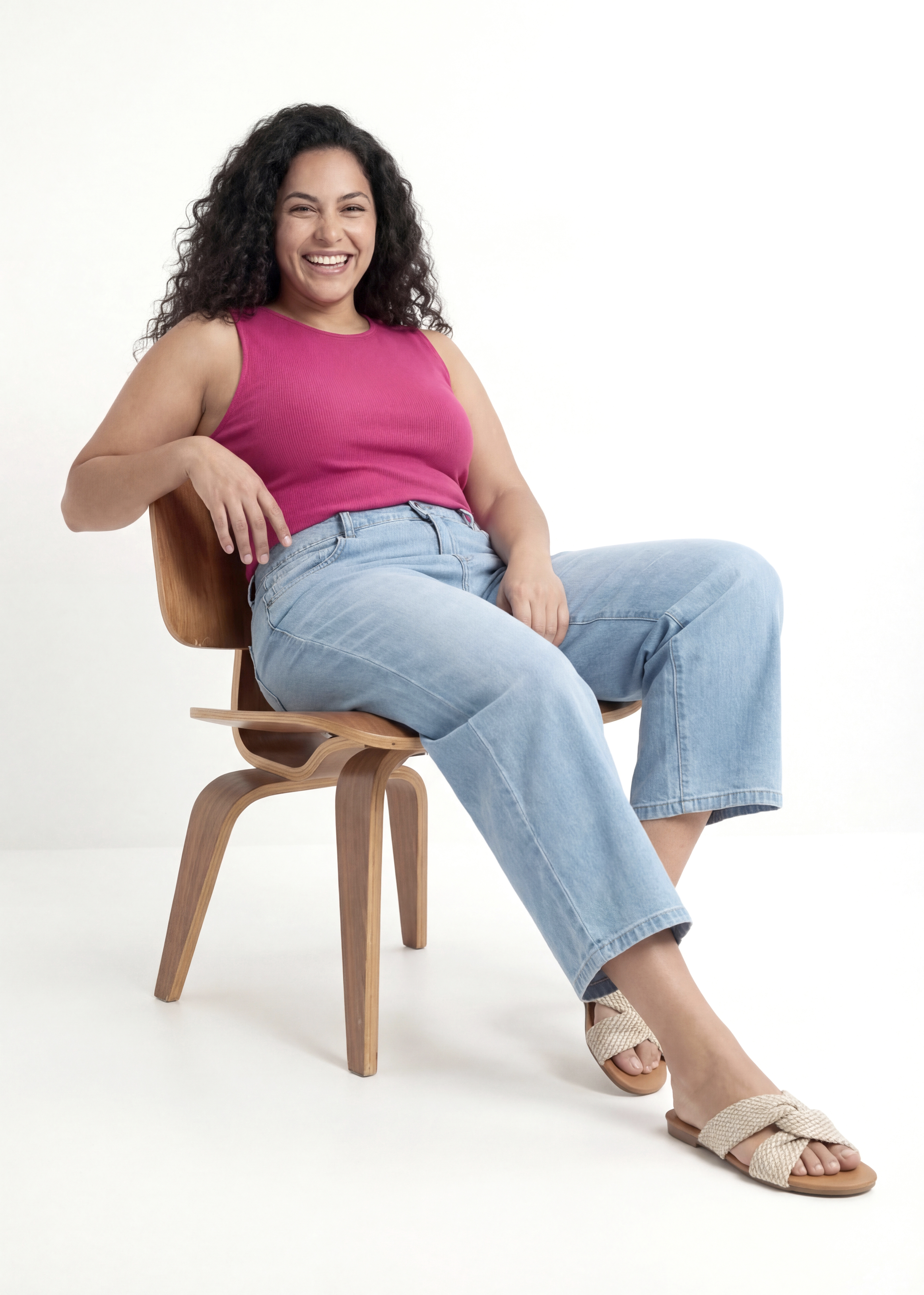 Her outfit: a pink vest top, loose-fitting jeans and woven sandals.