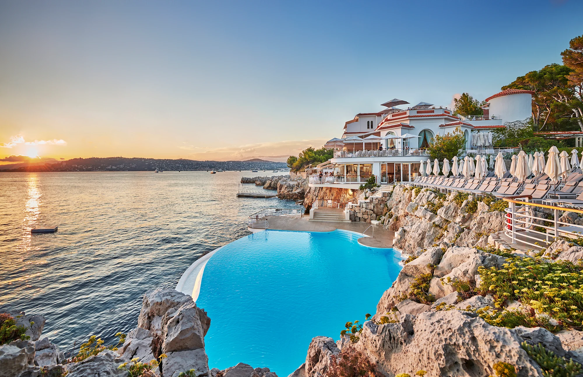 The Eden-Roc pool cut into the rocks above the sea at sunset, Antibes