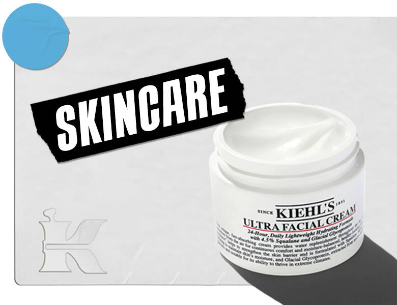 Her ses en lysegrå baggrund med et Kiehl's ansigtsprodukt i højre side. Til venstre ses et sort skilt med "skincare" i hvid. 