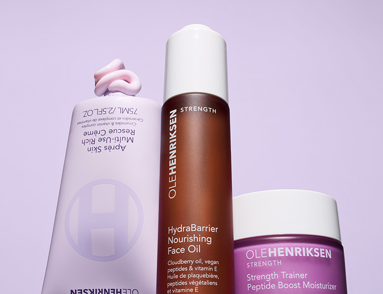 Her ses OLE HENRIKSEN hudplejeprodukter i lilla og brun emballage på en lys baggrund.