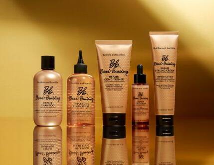 Her ses en guld baggrund med fem guld produkter. 