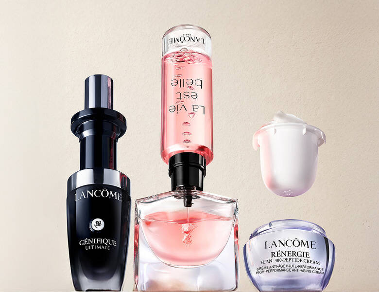 Her ses et billede med flere Lancôme-produkter placeret mod en lys baggrund. Produkterne inkluderer en flaske med teksten “LANCÔME GÉNIFIQUE ULTIMATE”, en parfumeflakon med lyserød væske, en flaske med teksten “La vie est belle” vendt på hovedet, samt en krukke med teksten “RÉNERGIE H.P.N. 300-PEPTIDE CREAM”.