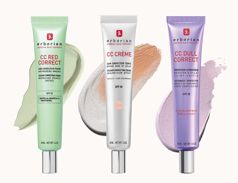 Her ses Erborian CC cremer i grøn, hvid og lilla emballage med produktteksturer på en lys baggrund.