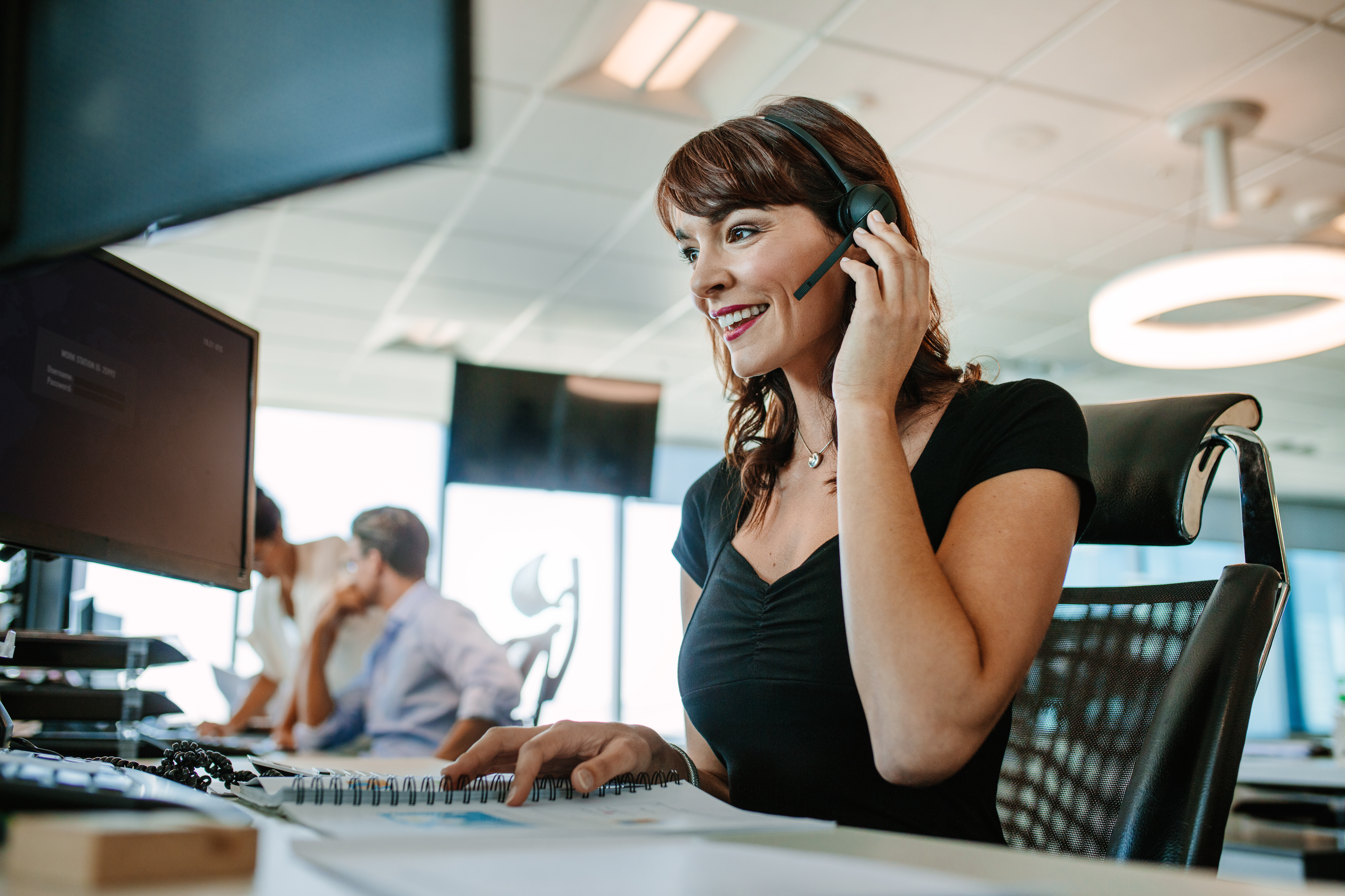 Woman speaking on the phone in a call center environment