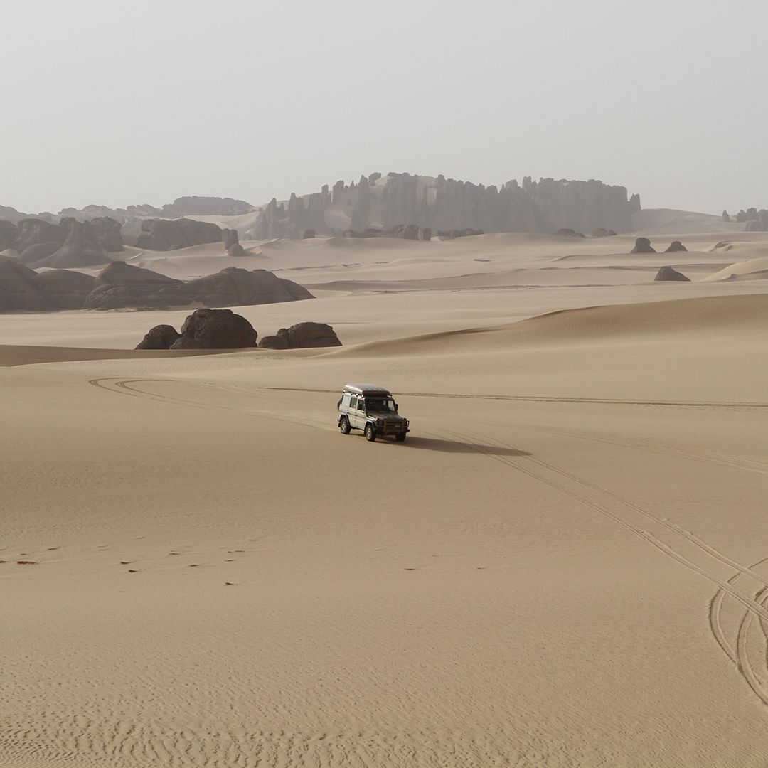 SUV overlanding in desert landscape