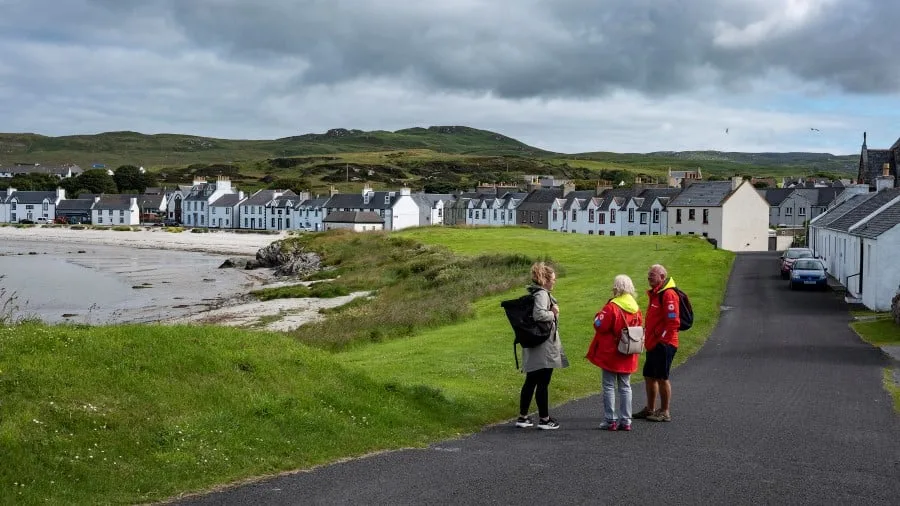 Guests walking through Port Ellen, Isle of Islay, Scotland. Credit: Tommy Simonsen. 