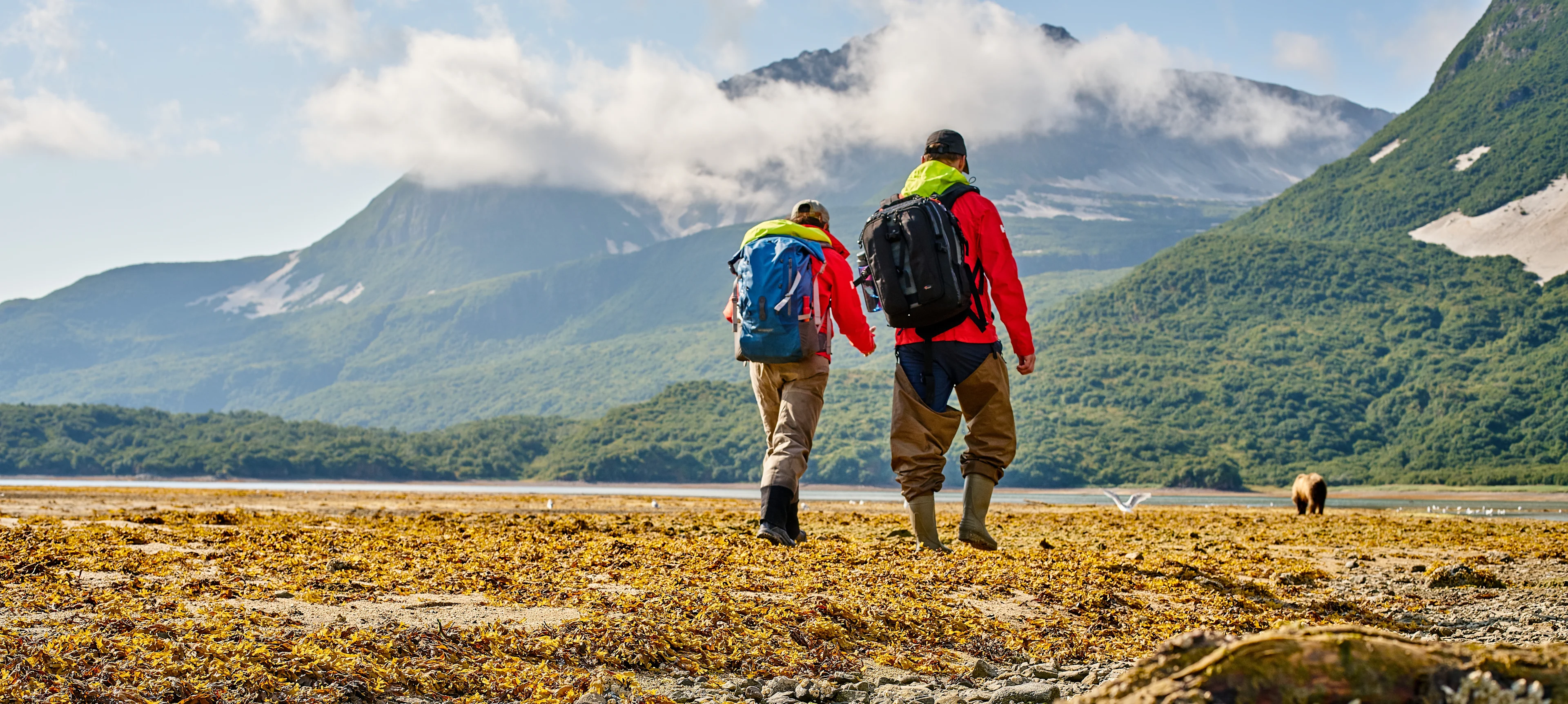 Couple walking through Geo Harbour in Katmai National Park, Alaska. Credit: Ashton Ray Hansen