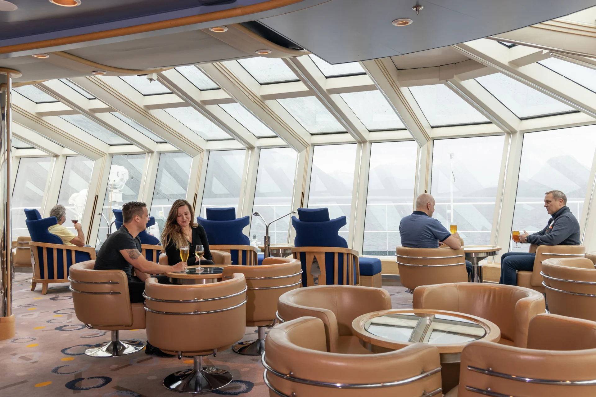 Guests relaxing in the Explorer Lounge & Bar onboard MS Fram. Credit Espen Mills