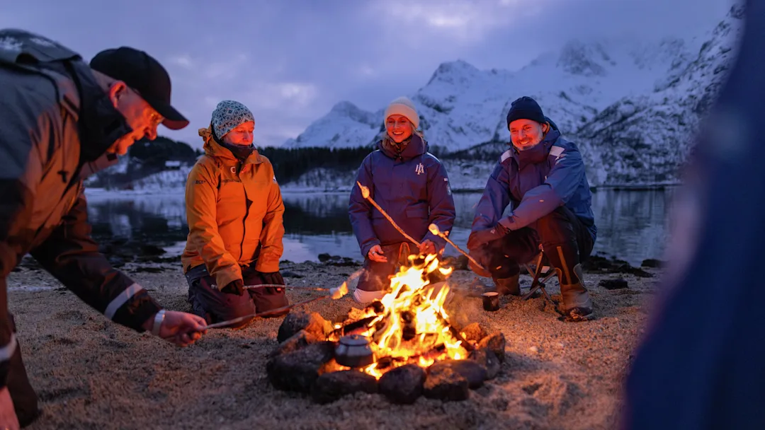 Toasting marshmallows on beach, Norway