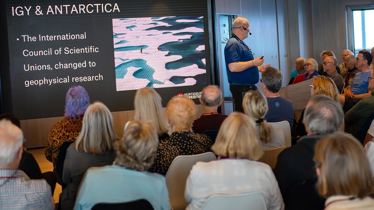 People following a lecture on board MS Roald Amundsen. Credit:  Espen Mills