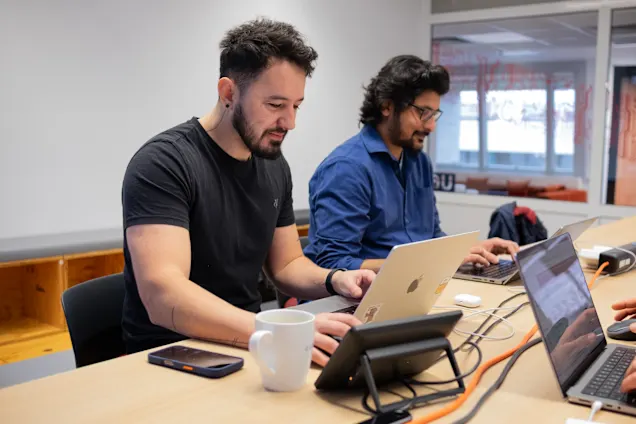 2 persons working on their laptops