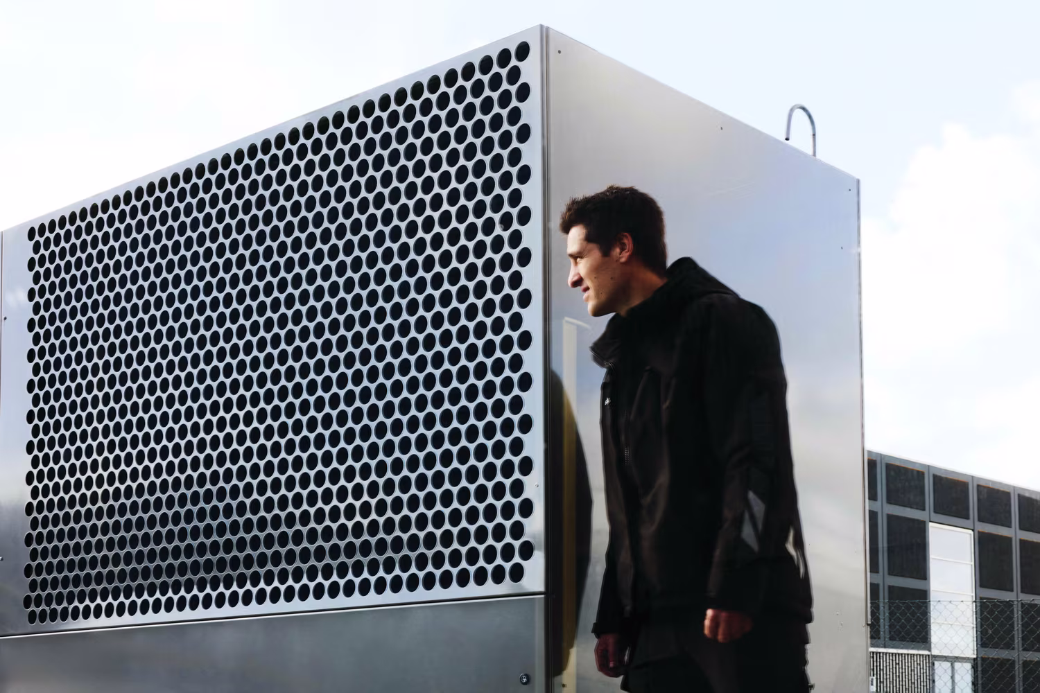 Man next to industrial heat pump