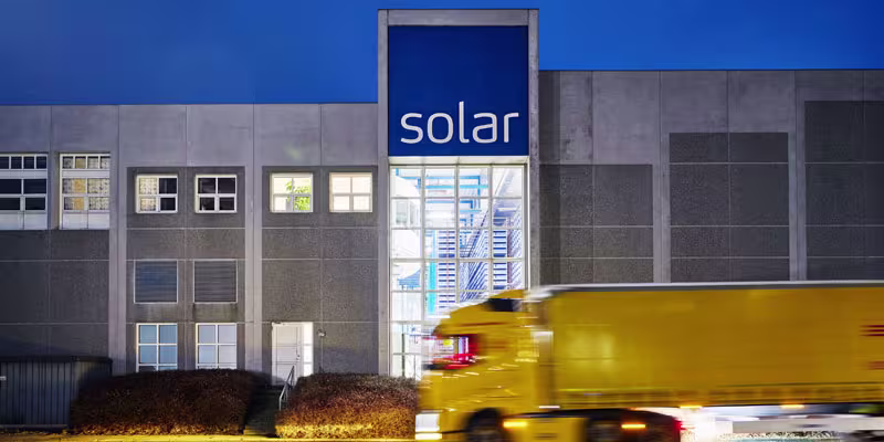 Yellow truck moving fast in front of Solar warehouse in Vejen Denmark