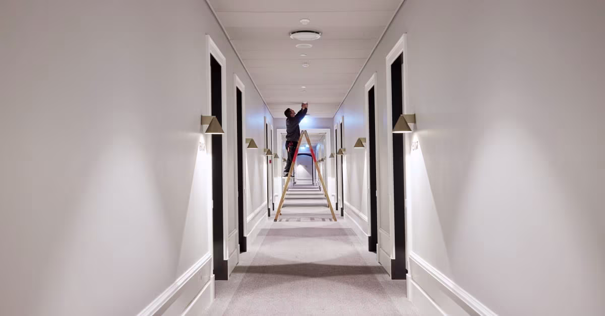 Installer working in a corridor