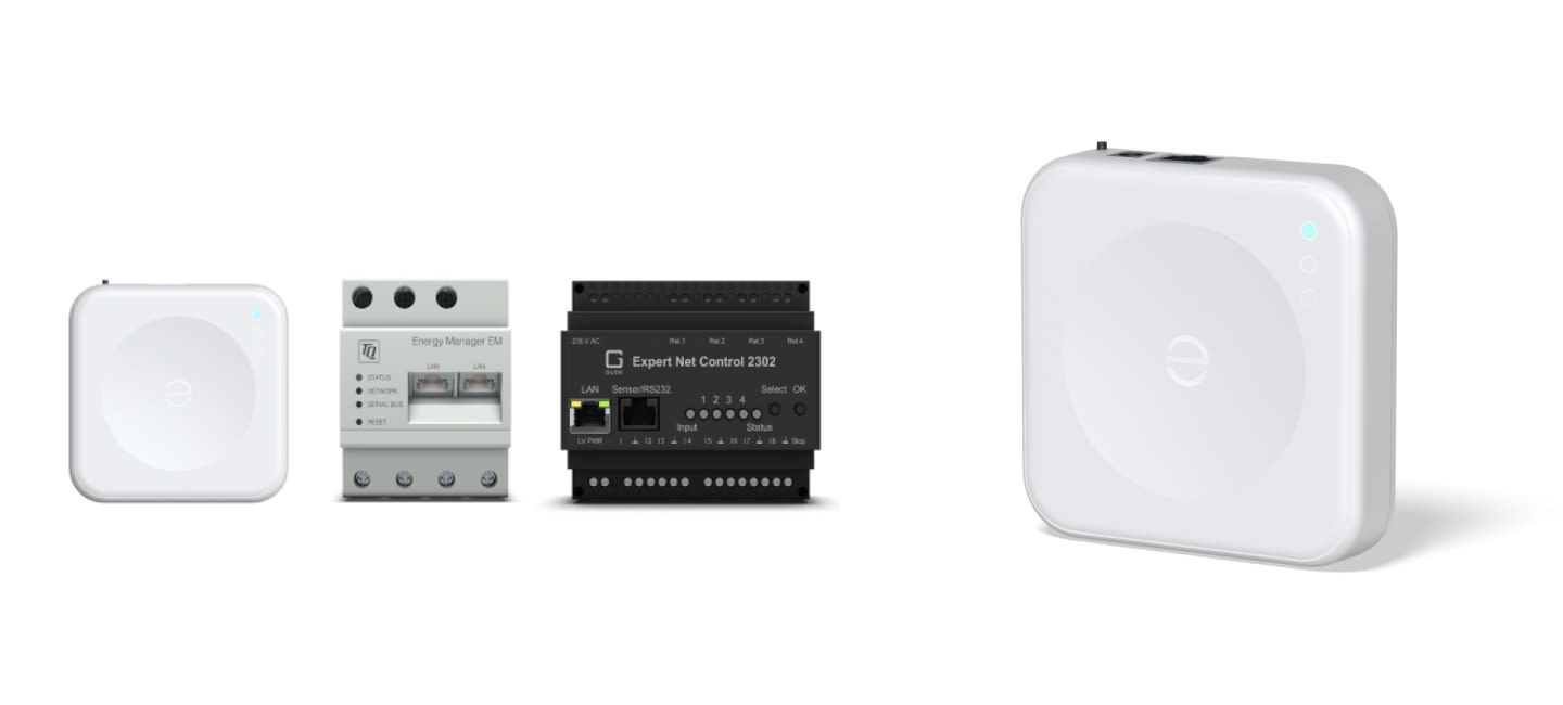 Four smart home devices including the Enphase IQ Energy Router are arranged side by side. They are sleek, rectangular, and feature buttons and ports, suggesting advanced technology.