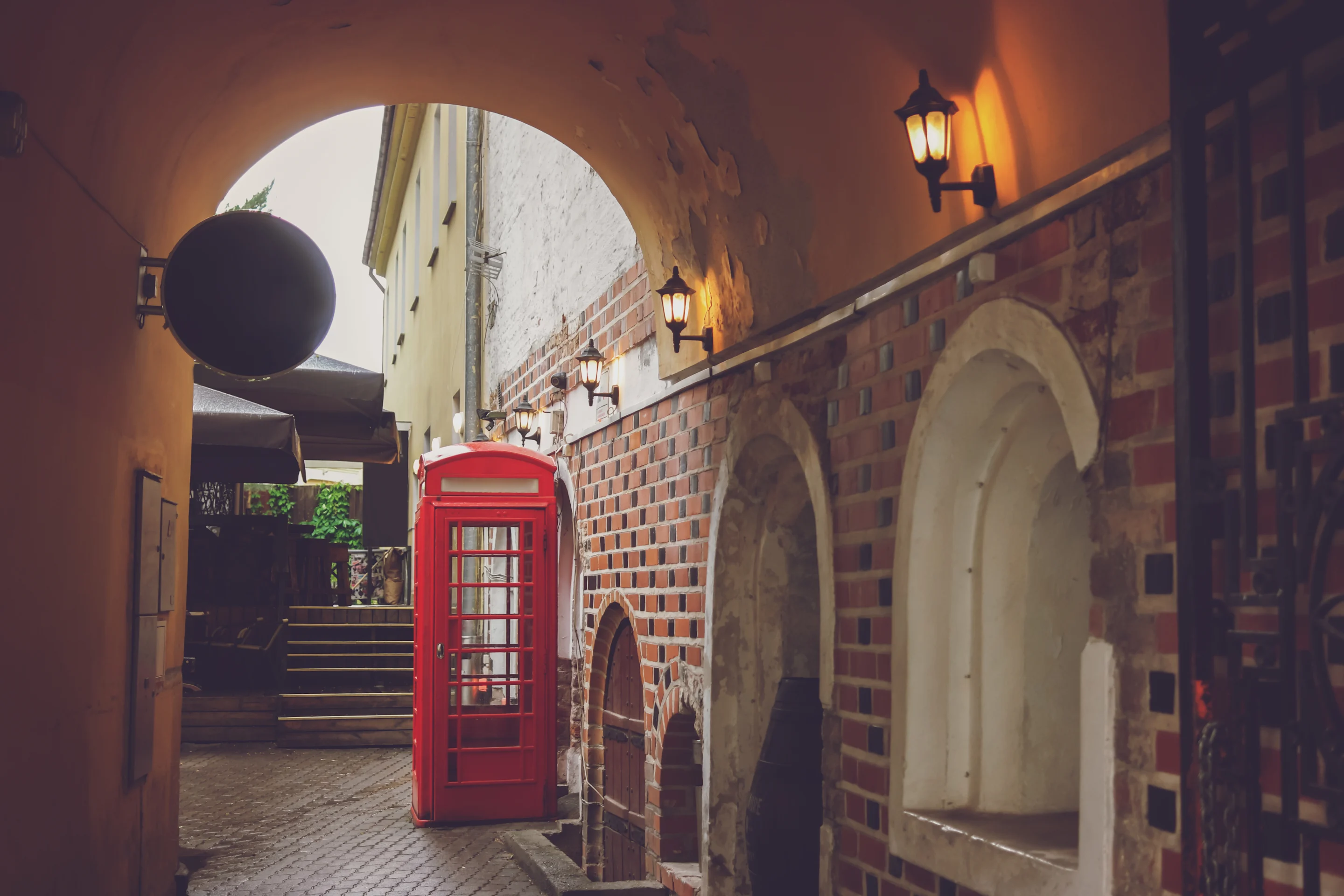 Red Phone Booth in brick alleyway